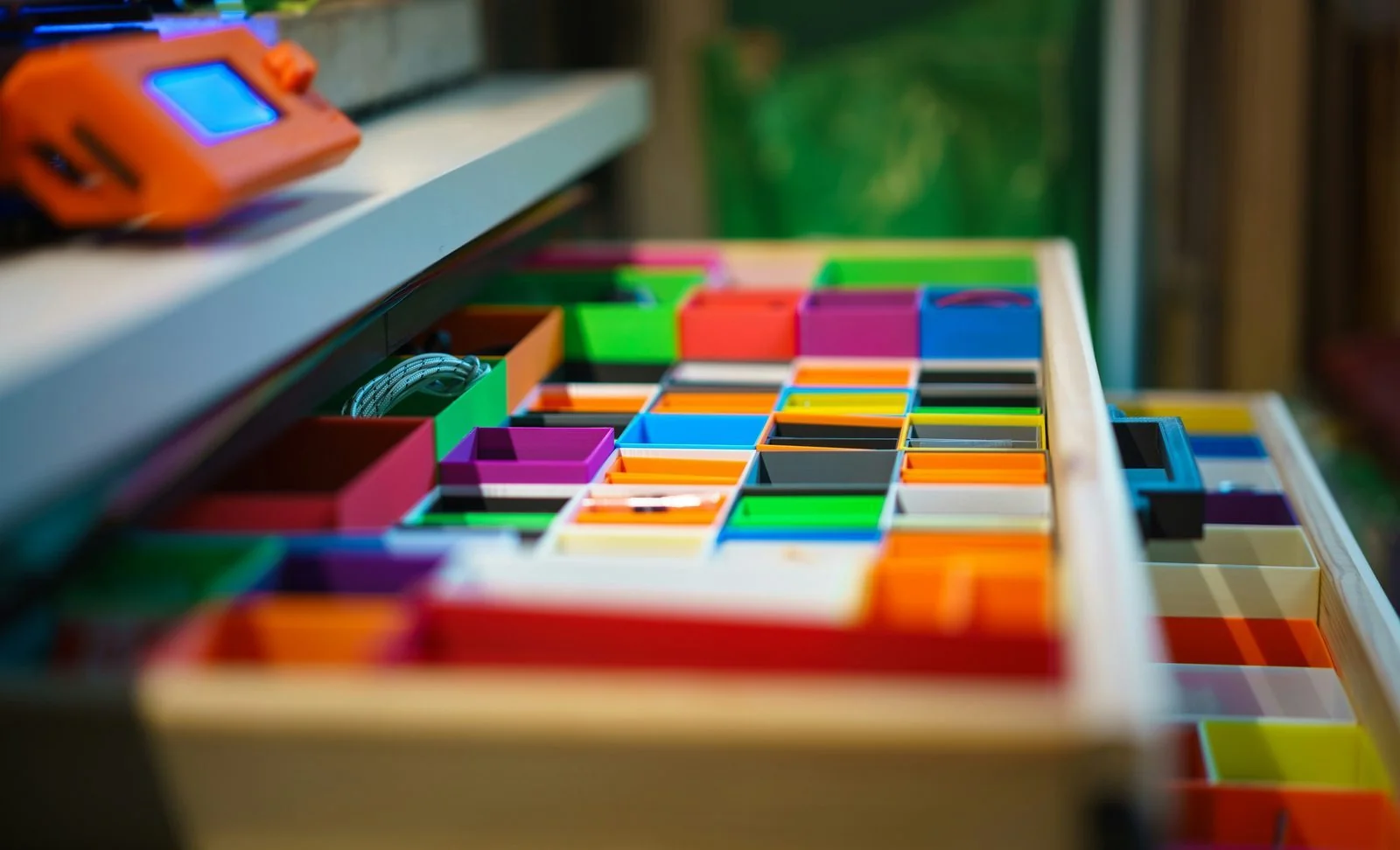 Drawer of colorful sensory blocks arranged neatly by color.