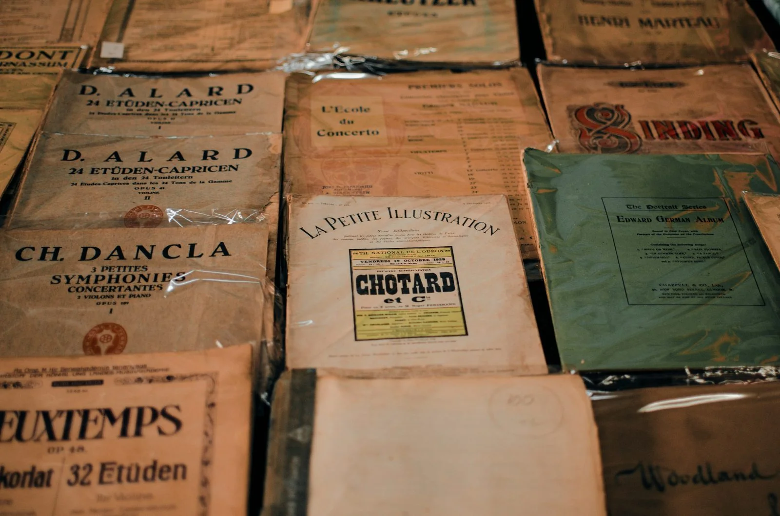 Vintage theatre and music programmes laid out on a wooden surface.